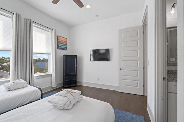 bedroom with dark hardwood / wood-style floors and ceiling fan