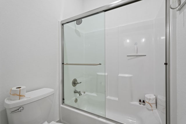 bathroom with enclosed tub / shower combo and toilet