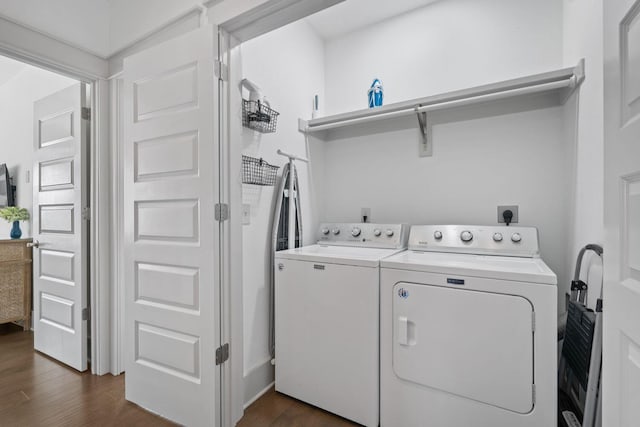 laundry room with separate washer and dryer and dark hardwood / wood-style floors