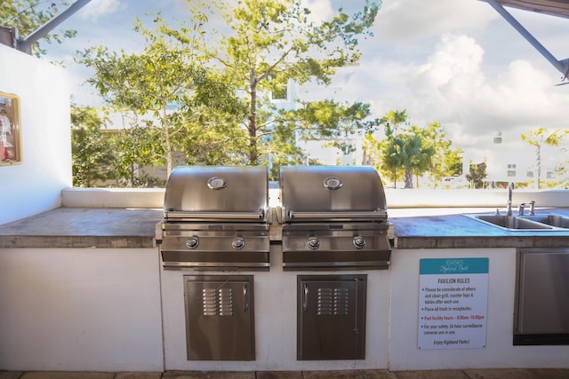 view of patio / terrace featuring sink, a grill, and exterior kitchen