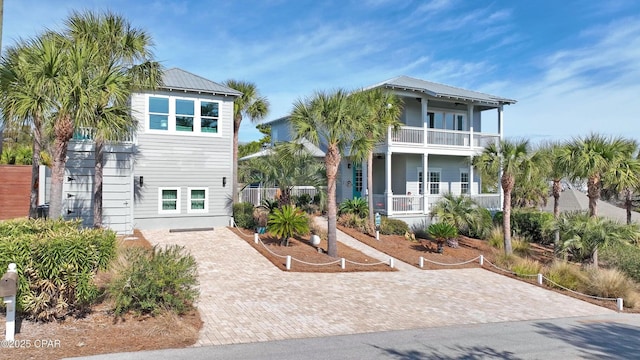 coastal inspired home featuring a balcony