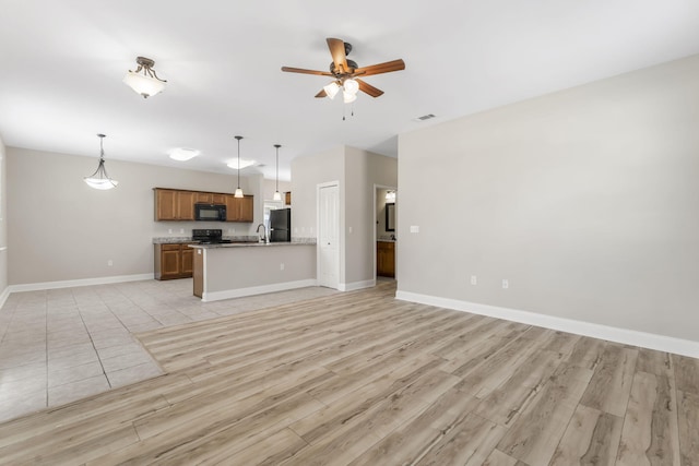 kitchen with decorative light fixtures, black appliances, ceiling fan, and light wood-type flooring