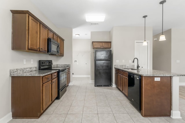 kitchen with decorative light fixtures, sink, light tile patterned floors, black appliances, and light stone countertops