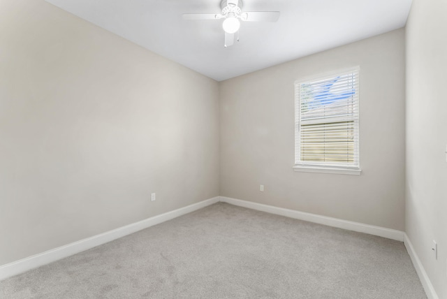 empty room with ceiling fan and light colored carpet