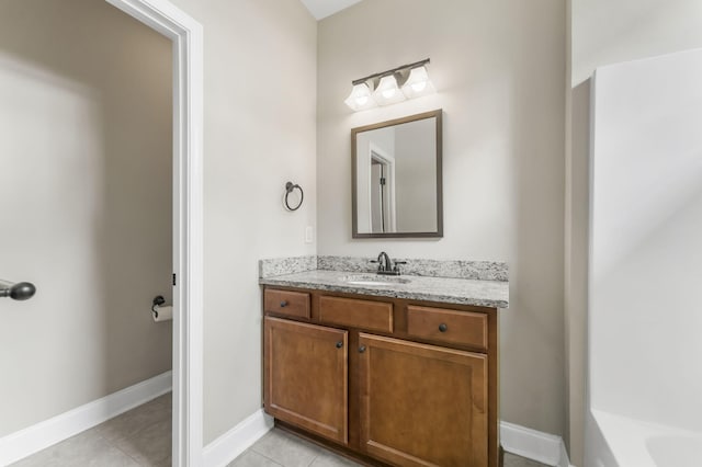 bathroom with tile patterned flooring, vanity, and a washtub