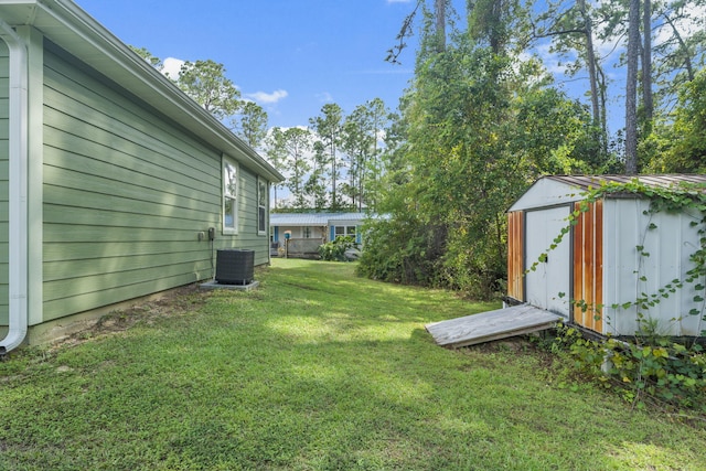 view of yard with a storage shed and central air condition unit