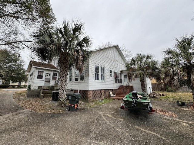 rear view of house with entry steps and central air condition unit