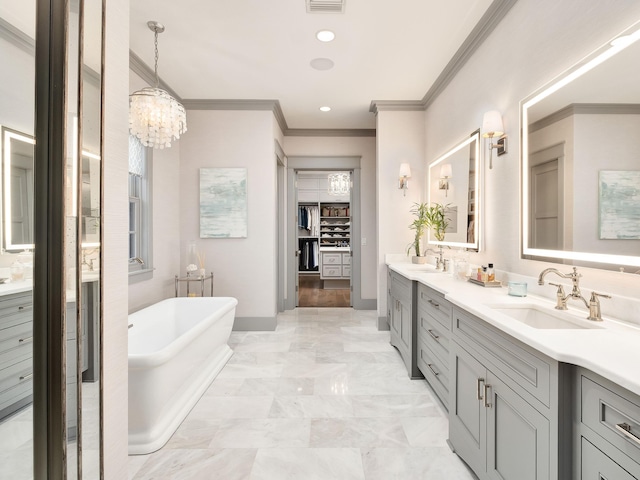 bathroom with a tub to relax in, vanity, a notable chandelier, and ornamental molding