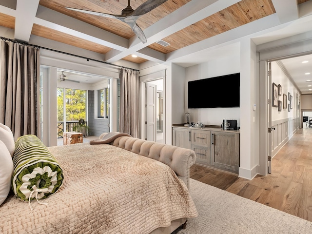 bedroom featuring beamed ceiling, coffered ceiling, access to exterior, and light hardwood / wood-style floors