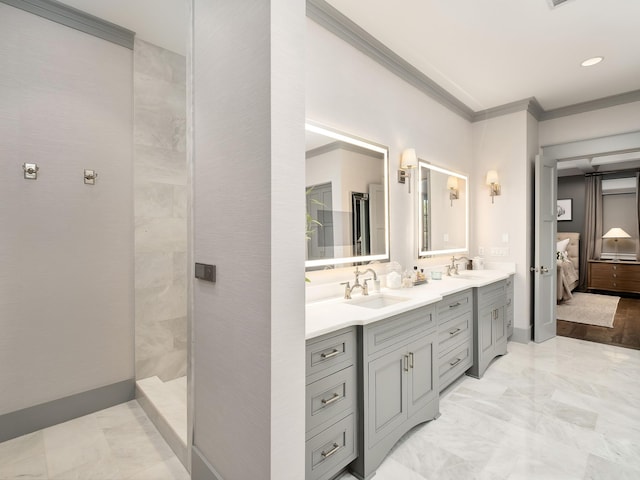 bathroom featuring ornamental molding, tiled shower, and vanity