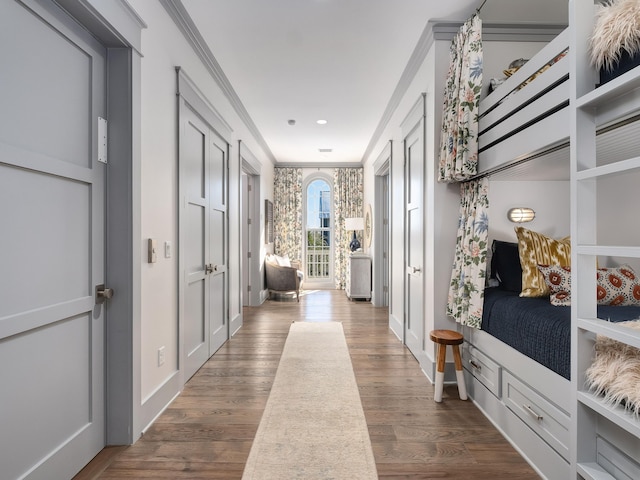 mudroom with crown molding and wood-type flooring