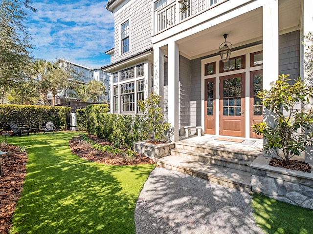 doorway to property featuring a lawn