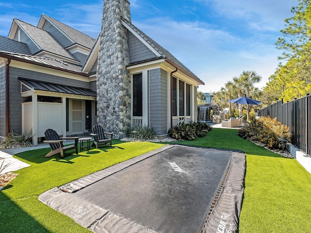 rear view of house with a patio and a yard