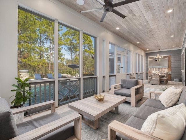 sunroom featuring ceiling fan with notable chandelier and wooden ceiling