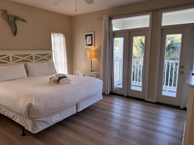 bedroom with dark wood-type flooring and access to outside