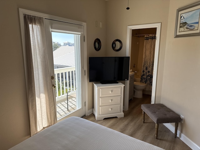 bedroom with access to exterior and light hardwood / wood-style floors