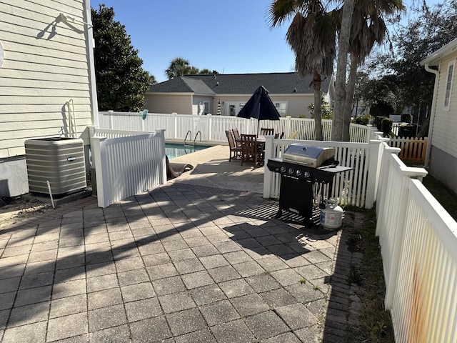 view of patio / terrace featuring cooling unit, a grill, and a fenced in pool