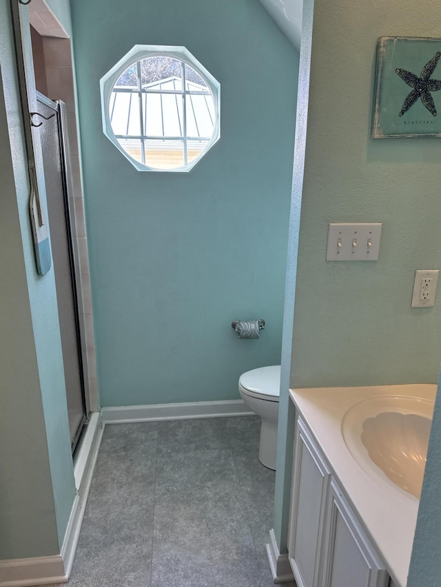 bathroom with vanity, an enclosed shower, and toilet