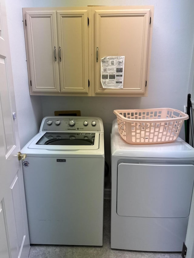 washroom with cabinets and independent washer and dryer