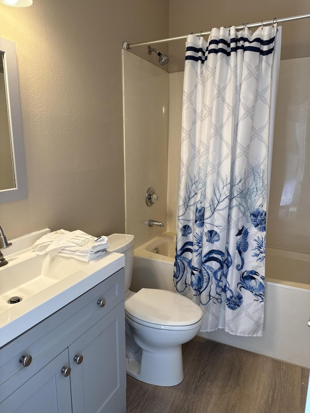 full bathroom with vanity, hardwood / wood-style flooring, shower / bath combination with curtain, and toilet