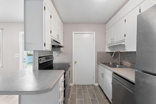 kitchen with appliances with stainless steel finishes, tasteful backsplash, white cabinetry, sink, and kitchen peninsula