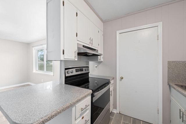 kitchen featuring dark wood-type flooring, kitchen peninsula, stainless steel range with electric cooktop, and white cabinets