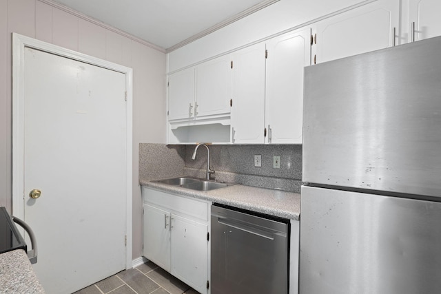 kitchen with sink, stainless steel appliances, ornamental molding, white cabinets, and decorative backsplash