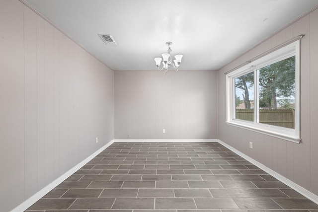 empty room featuring a chandelier