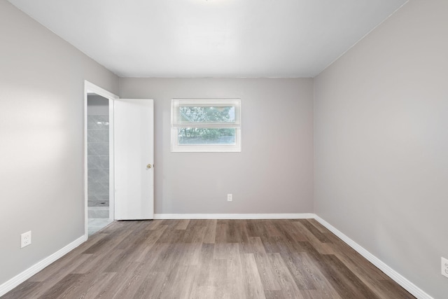 spare room with hardwood / wood-style flooring