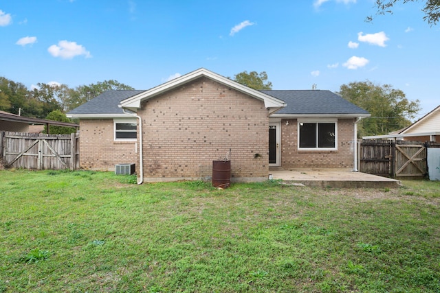 back of house featuring cooling unit, a yard, and a patio area