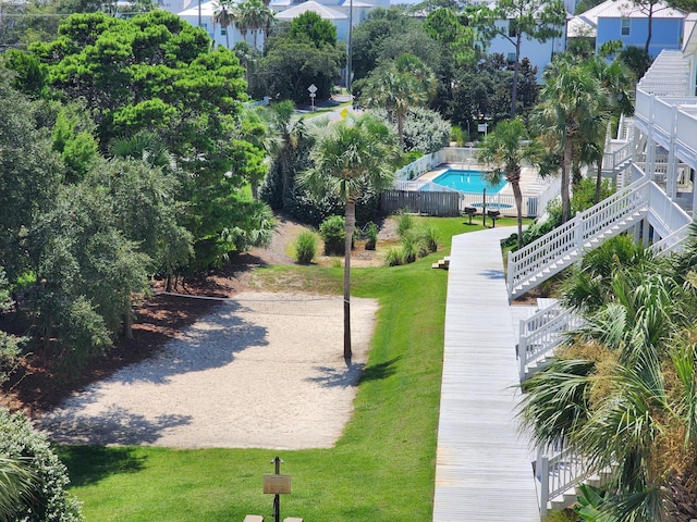 view of community with a pool and a lawn