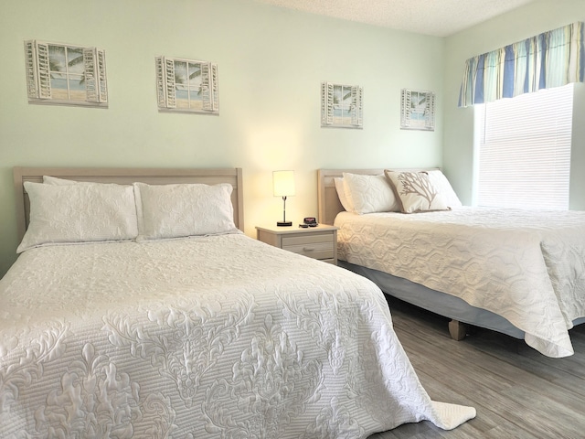 bedroom with wood finished floors and a textured ceiling