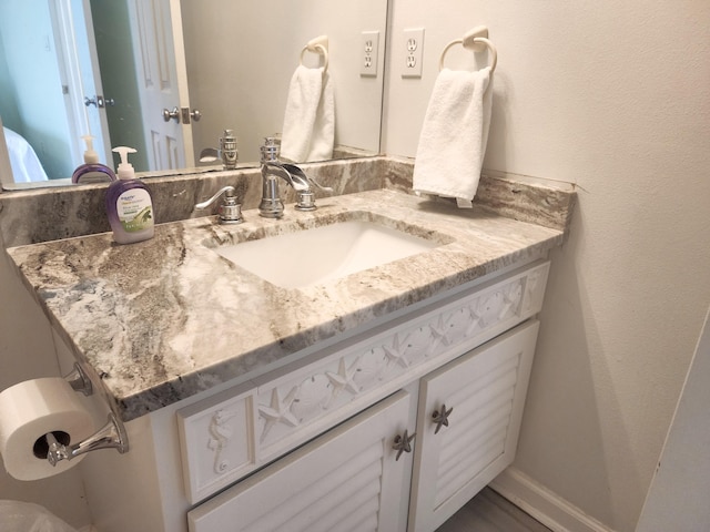 bathroom with vanity and baseboards