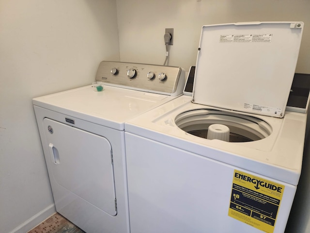 laundry area featuring washer and clothes dryer, laundry area, and baseboards