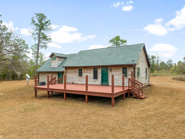 rear view of house with a yard, central AC, and a deck