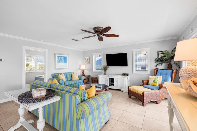 living room with a wealth of natural light, visible vents, and crown molding