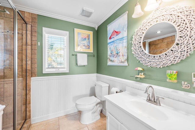 full bath featuring toilet, a shower stall, crown molding, and wainscoting