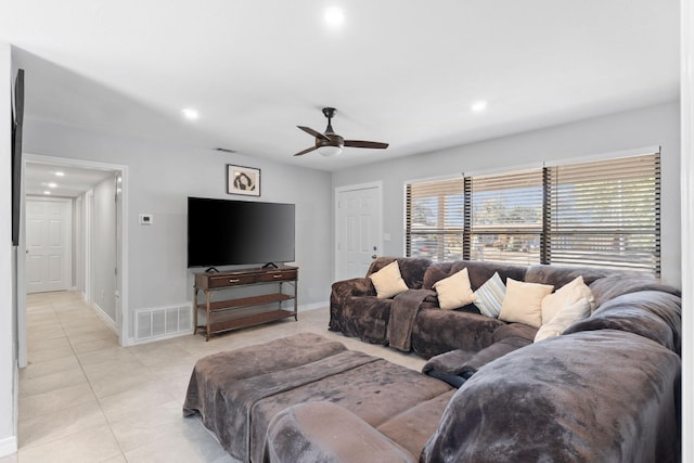 tiled living room featuring ceiling fan