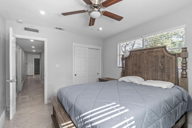 tiled bedroom featuring ceiling fan and a closet