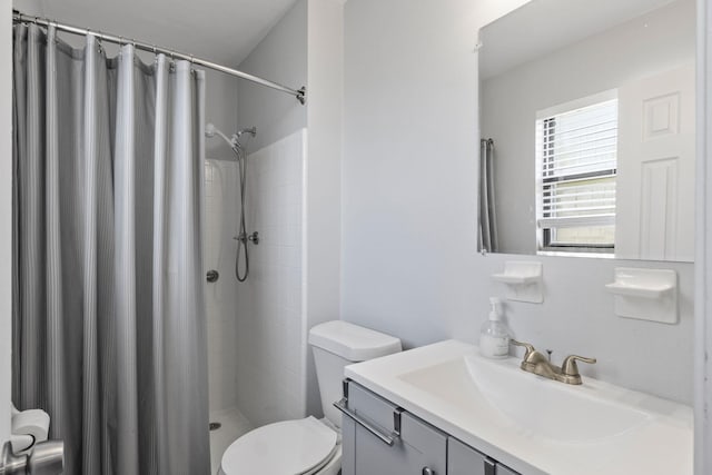 bathroom featuring toilet, vanity, and a shower with shower curtain