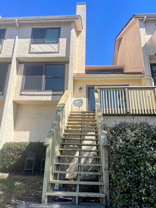 view of front of home featuring stairs and stucco siding