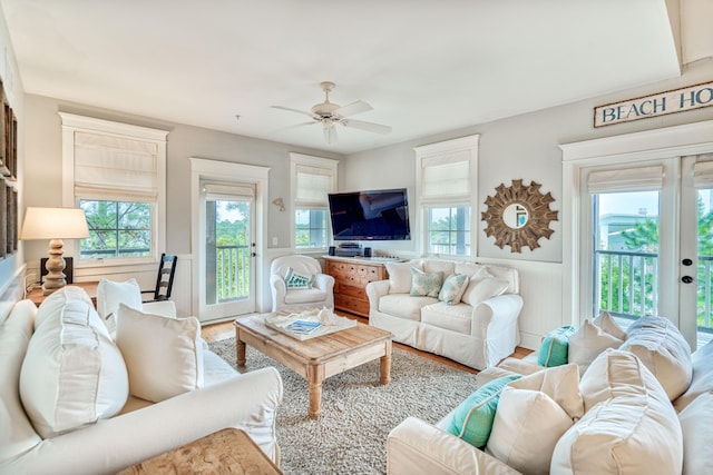 living room with hardwood / wood-style floors, french doors, and ceiling fan