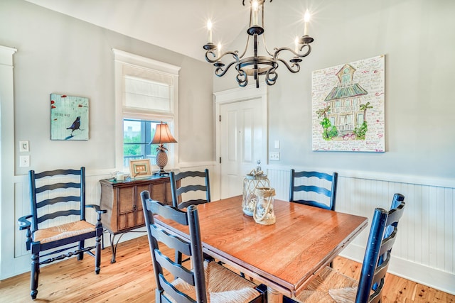 dining room featuring light wood-type flooring and a notable chandelier