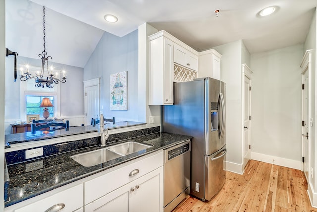 kitchen with dark stone countertops, sink, white cabinets, and dishwasher