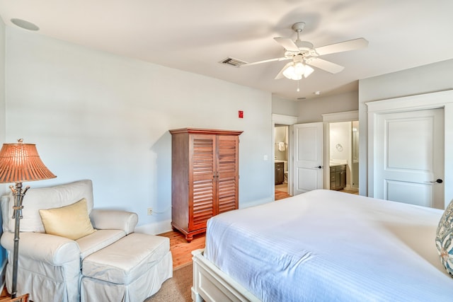 bedroom featuring ceiling fan, connected bathroom, and light hardwood / wood-style flooring