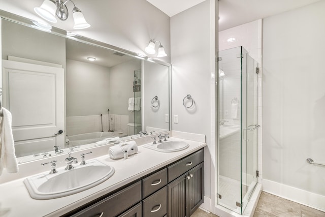 bathroom with vanity, toilet, tile patterned flooring, and a shower with door