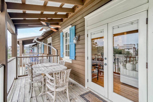 wooden terrace featuring french doors and ceiling fan