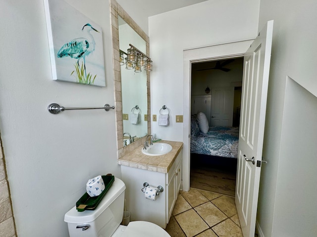 bathroom with tile patterned flooring, vanity, and toilet