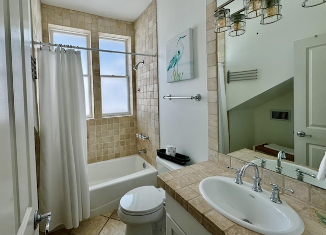 full bathroom with shower / tub combo with curtain, vanity, toilet, and tile patterned floors