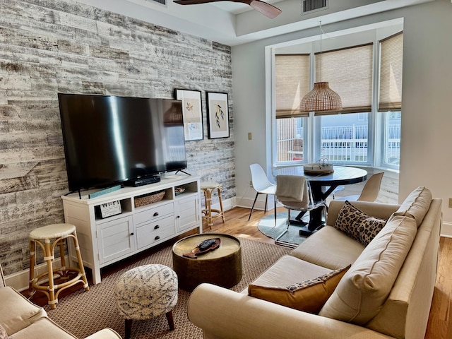 living room featuring ceiling fan and light hardwood / wood-style flooring